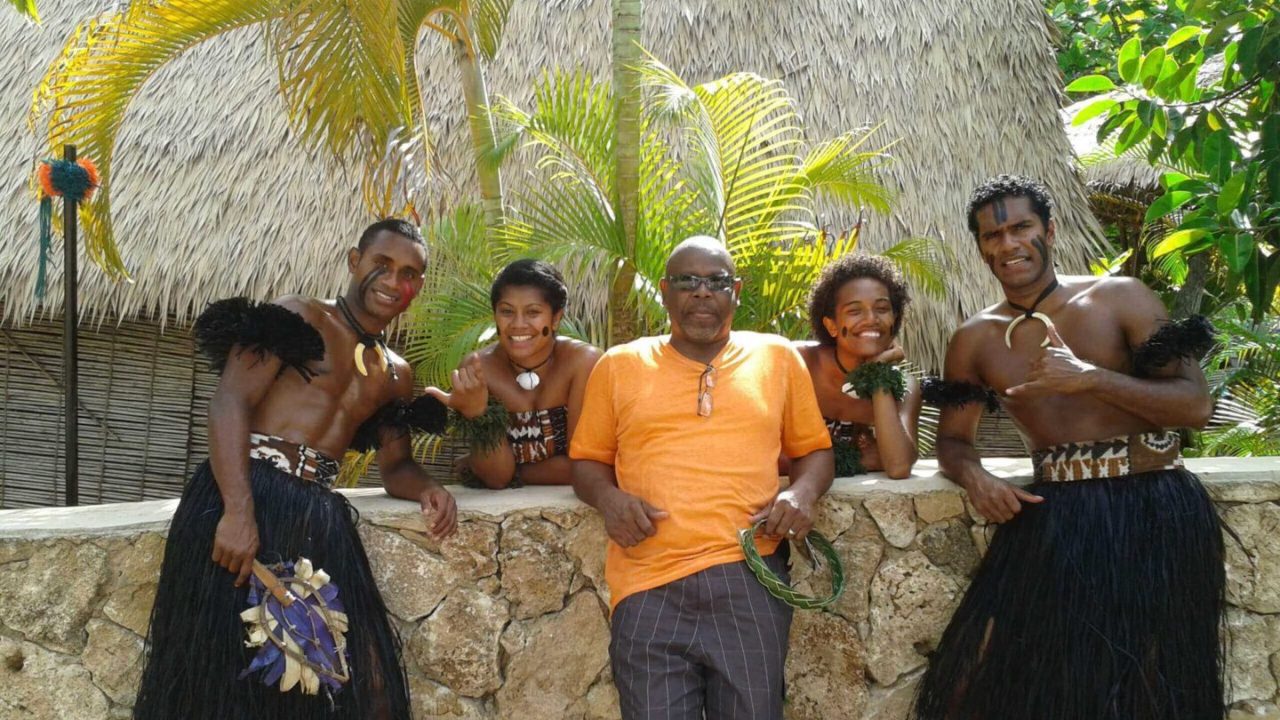 Group photo with dancers in traditional attire.