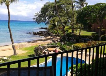 Tropical beach view with pool and palm trees