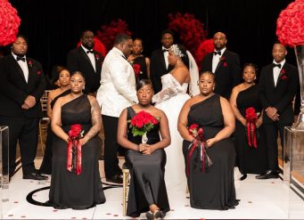 Bride & Groom surrounded by wedding party.