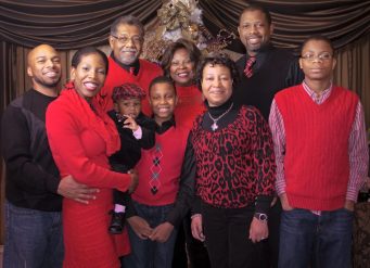 Smiling extended family dressed in red