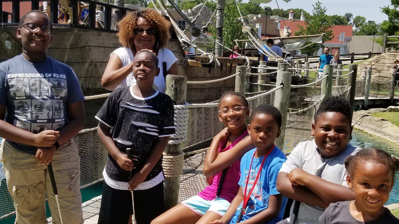 Family enjoying pirate-themed mini golf.